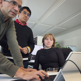 An intern with 2 colleagues looking at the screen in the office of Hemex AG in Liestal, Switzerland